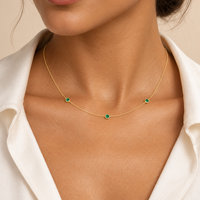 AI-generated model styling view of the three-emerald station necklace in 14K yellow gold