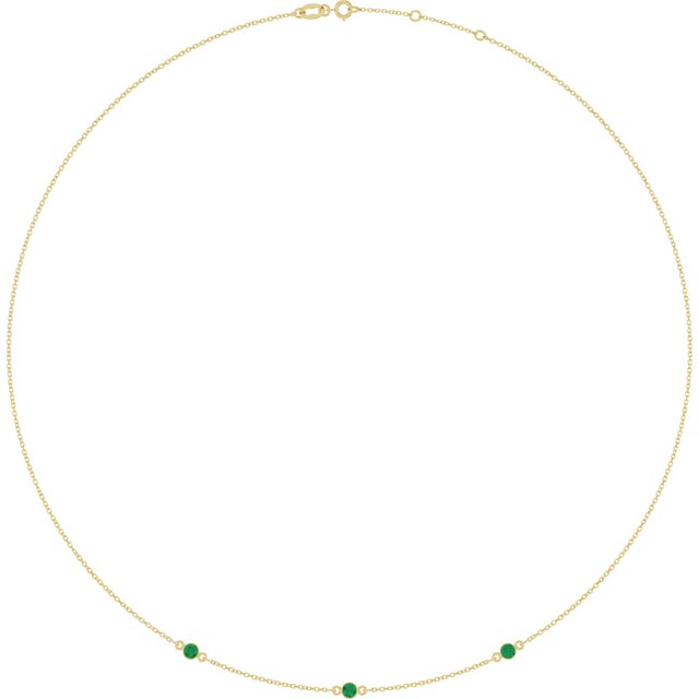 Three lab-grown emeralds in 14K yellow gold bezel settings on an adjustable necklace