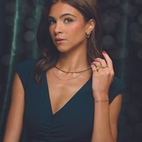Model wearing the herringbone necklace layered with other jewelry, sold separately
